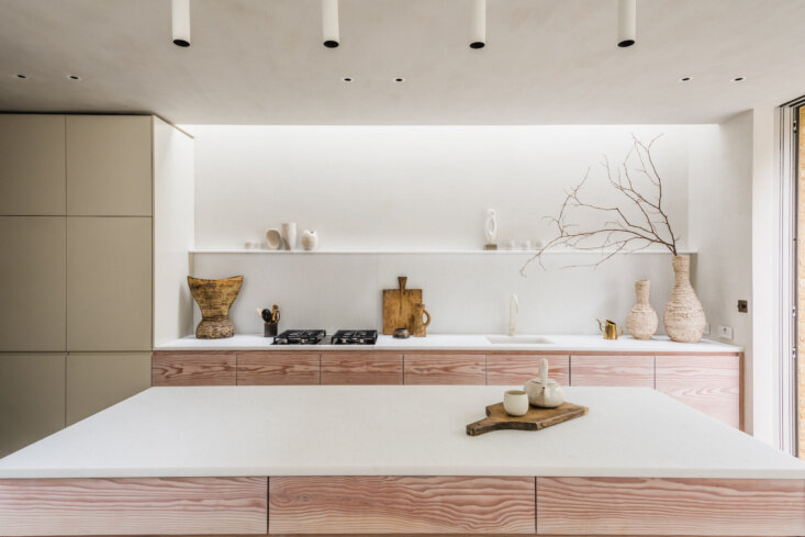 Evora marble runs across the kitchen counter and backsplash above bespoke Douglas fir drawer fronts and flush painted uppers.