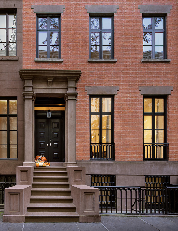 The restored brick facade keeps the townhouse anchored in its historic streetscape.